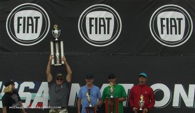 2014 Nssa National Championships In Hb. Video Photo.
2014 NSSA National Kneeboard Champion, Sean Noone, hoists the trophy while on stage with; Paul Devoy, Chris Bermudez and Ken Cherryholmes, right.
